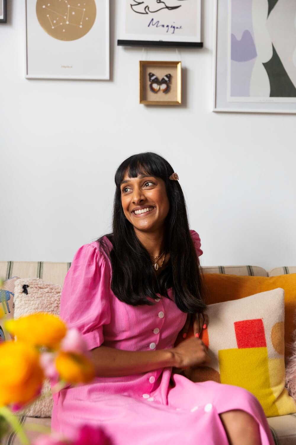 Zeena shah on sofa looking out of the window of her listed building home