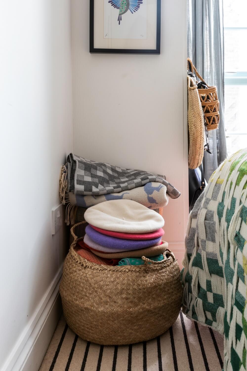 Small basket of hats next to the end of the bed for additional storage