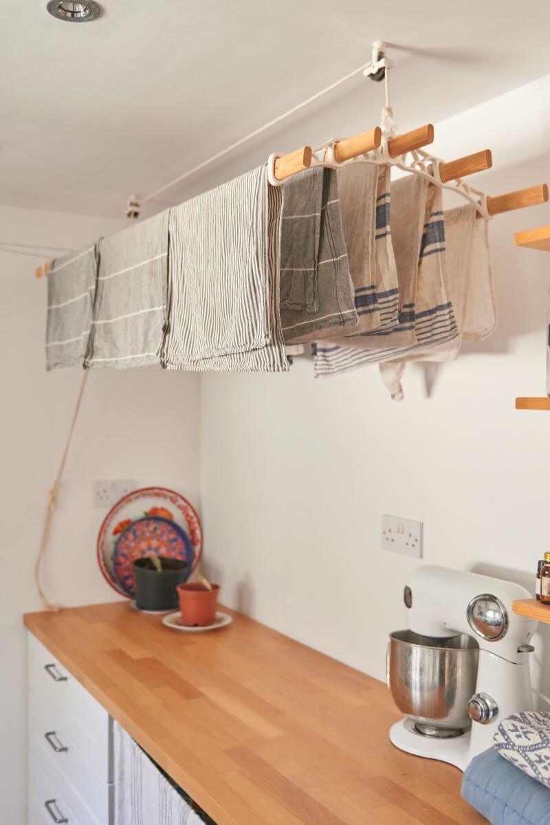 Peg hooks with broom hanging in the utility room