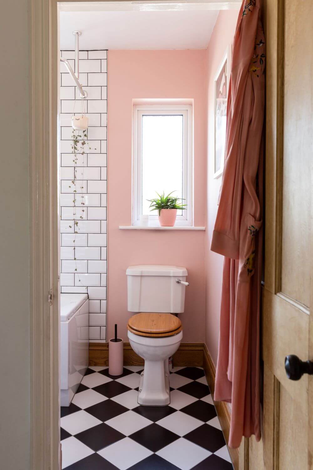 Decorate with Pink Home tour: Bathroom painted pink with black and white checked floor.