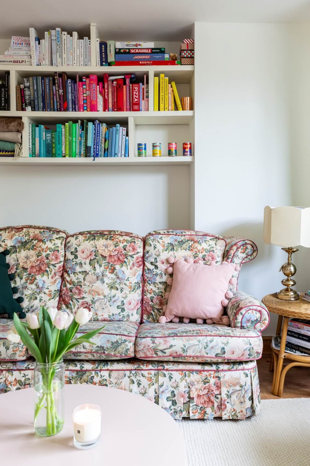 Decorate with Pink Home tour: Floral vintage sofas in a living room against a wall with books organised by colour