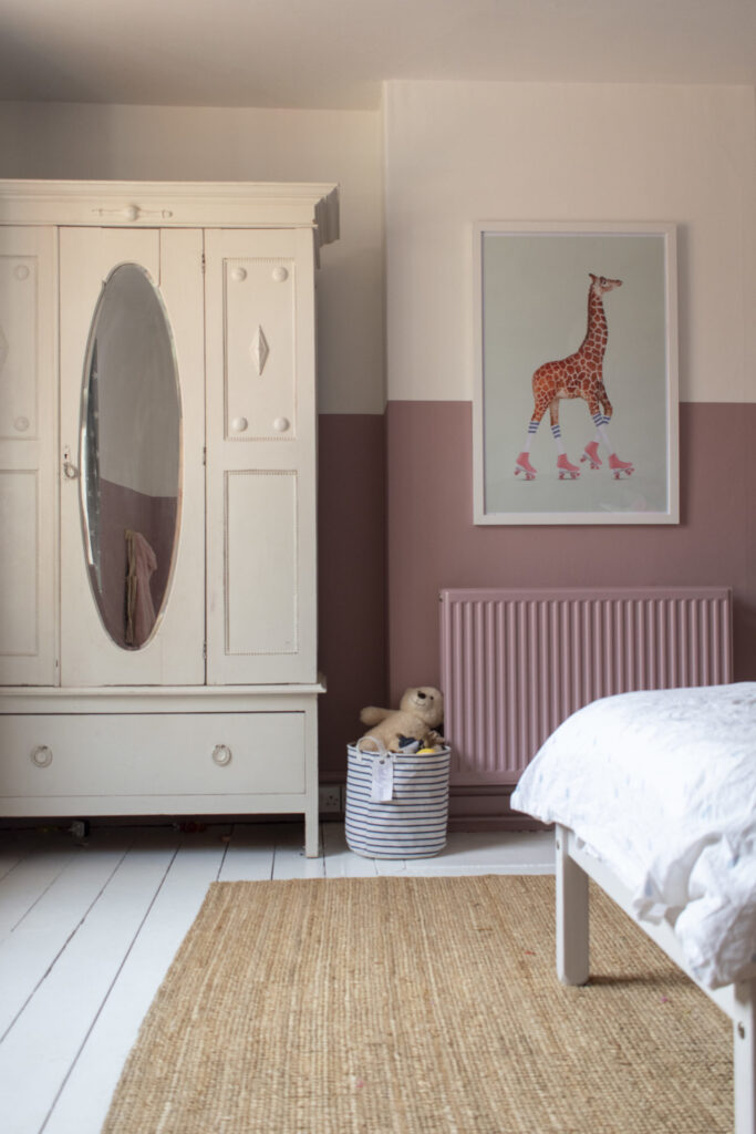 Half painted pink wall the helps radiator to blend into the wall 