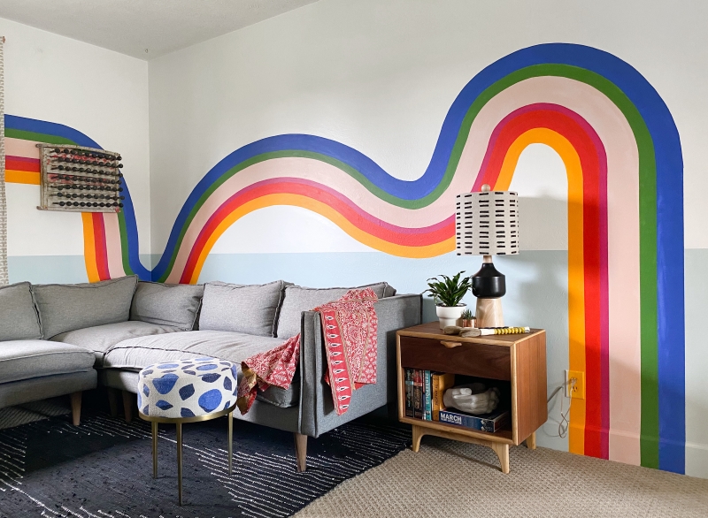Corner sofa with brown side table and diy bold and colourful wall mural