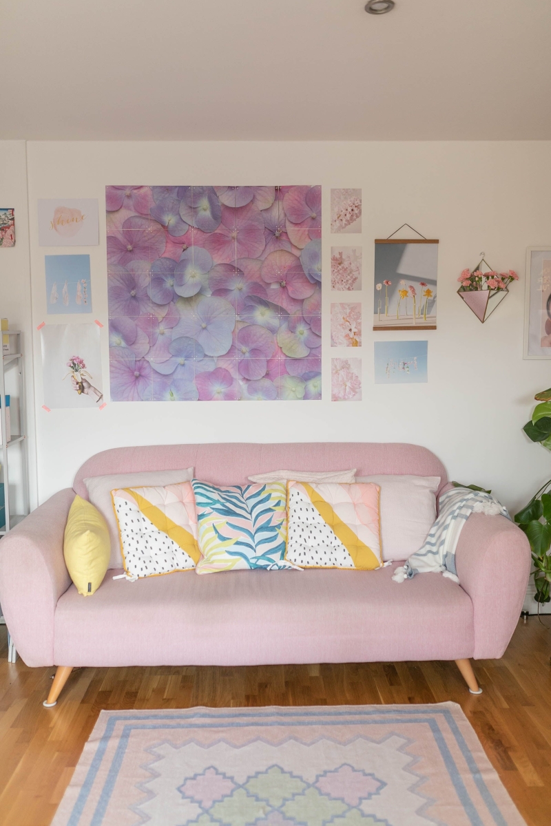Pastel coloured pink  sofa with colourful cushions 